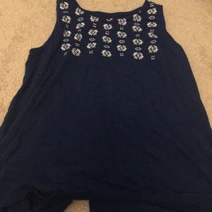 White patterning on navy blue tank top